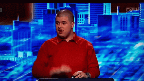 Bald Man in Red Shirt in Front of TV
