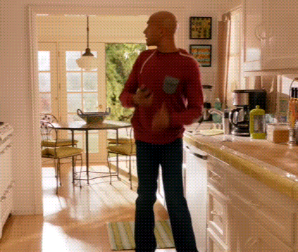 Bald Man in Red Shirt in Kitchen