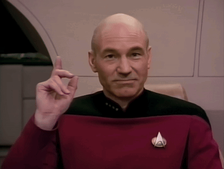 Bald Man in Red Uniform with Star Trek Badge