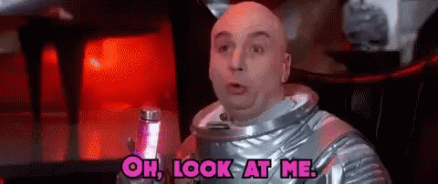 Bald Man in Space Suit Holding Lamp