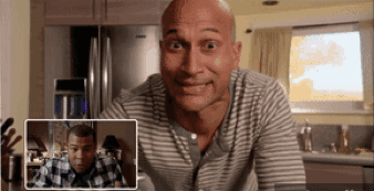 Bald Man in Striped Shirt Looking at Another Bald Man