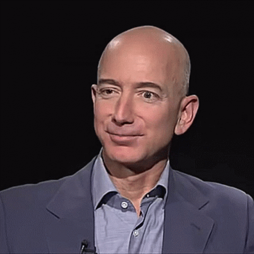 Bald Man in Suit and Blue Shirt Smiling