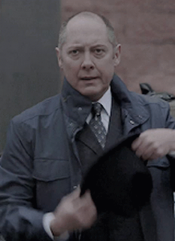 Bald Man in Suit and Tie Holding Black Hat