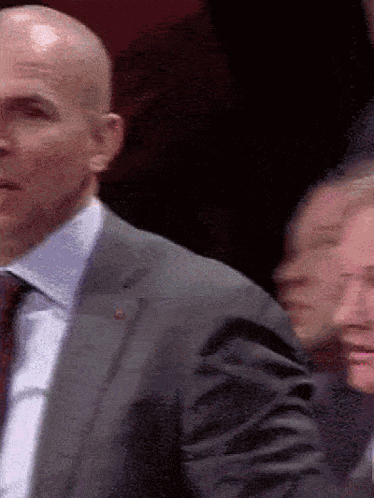 Bald Man in Suit and Tie in Crowd