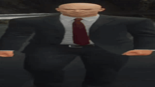 Bald Man in Suit and Tie in Dark Room
