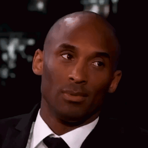 Bald Man in Suit and Tie Looking at Camera