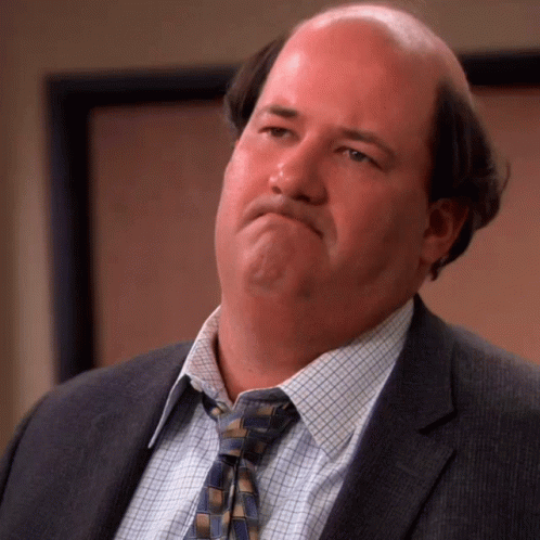 Bald Man in Suit and Tie Making Face