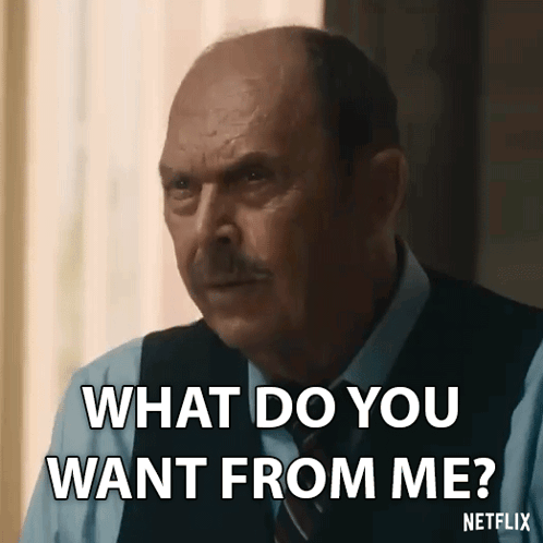Bald Man in Suit Asking What Do You Want From Me