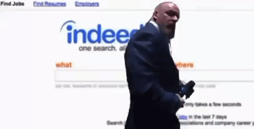 Bald Man In Suit Looking At Website Index GIF