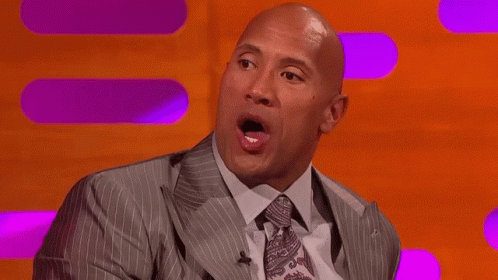Bald Man In Suit Making Funny Face On Stage GIF