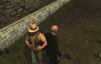 Bald Man in Suit Next to Man in Hat