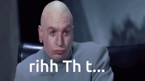 Bald Man in Suit Saying Rihhh Th T