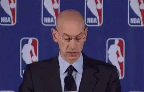 Bald Man In Suit Smiling At Microphone GIF