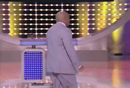 Bald Man In Suit Standing Before Blue Light GIF