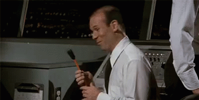 Bald Man in White Shirt Holding Brush