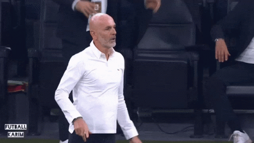 Bald Man in White Shirt Raising Arms Futbol Karim