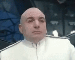 Bald Man in White Uniform Sitting