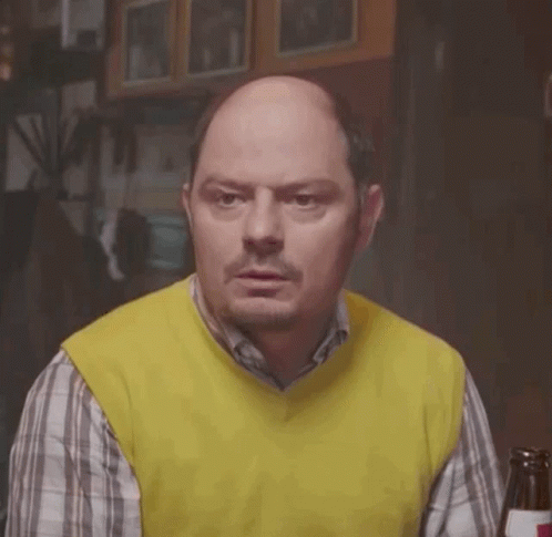 Bald Man In Yellow Vest And Plaid Shirt With Beer GIF