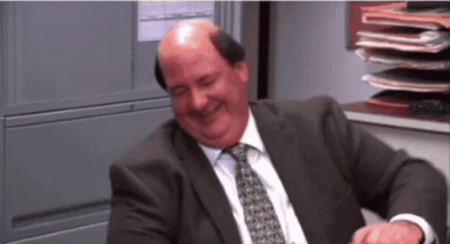 Bald Man Laughing in Suit and Tie