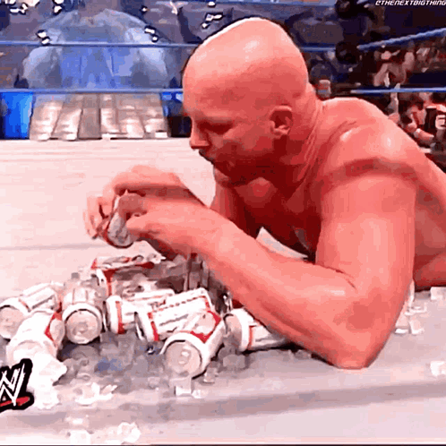 Bald Man Laying on Floor Eating Budweiser
