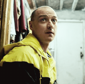 Bald Man Looking Sideways Yellow Black Jacket