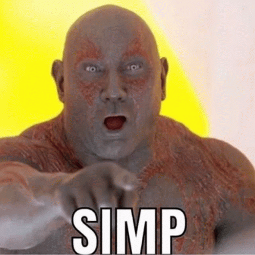 Bald Man Pointing at Camera With Word Simp