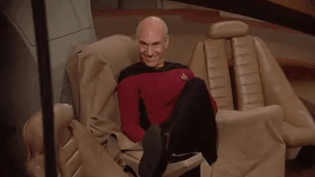 Bald Man Sitting Crossed Legs Smiling