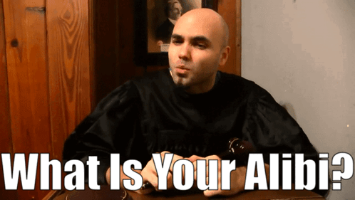 Bald Man Sitting with What Is Your Alibis