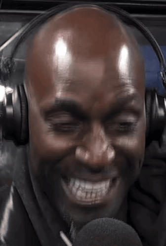 Bald Man Smiling In Headphones And Microphone GIF