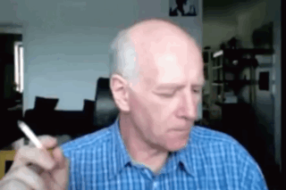 Bald Man Smoking Cigarette In Blue Shirt GIF