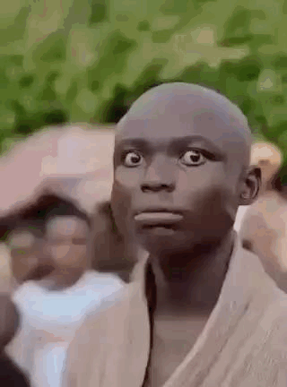 Bald Man Surprised In Front Of Crowd GIF