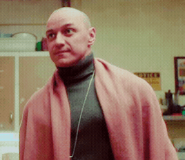 Bald Man Turtleneck Pink Scarf Looks at Camera