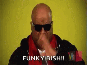 Bald Man Wearing Sunglasses and Red Scarf Making Funny Face