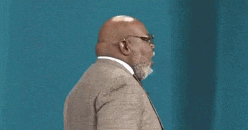 Bald Man With Beard and Glasses in Suit and Tie