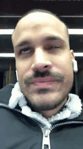 Bald Man With Beard And Mustache Wearing Headphones And Black Jacket GIF