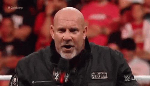 Bald Man With Beard at Microphone