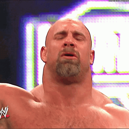 Bald Man With Beard in Front of WWE Logo