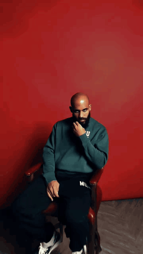 Bald Man With Beard in Green Sweater Saying U