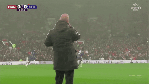 Bald Man With Beard Standing In Front Of Hisense Machine GIF