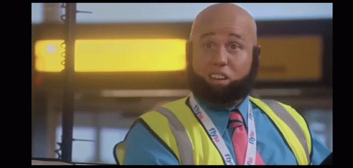 Bald Man With Beard Wearing Yellow Vest And TV Lanyard GIF