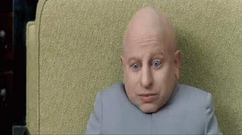 Bald Man With Blue Eyes Looking At Camera GIF