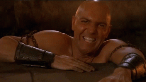 Bald Man With Chains Laying Down