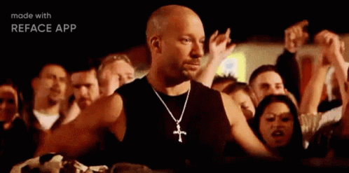 Bald Man With Cross Necklace at Concert
