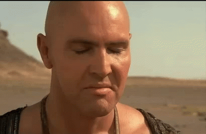 Bald Man With Eyes Closed in Desert