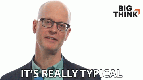 Bald Man With Glasses and Suit Says It's Really Typical
