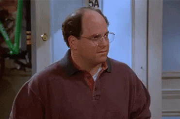 Bald Man With Glasses and Sweater at Door
