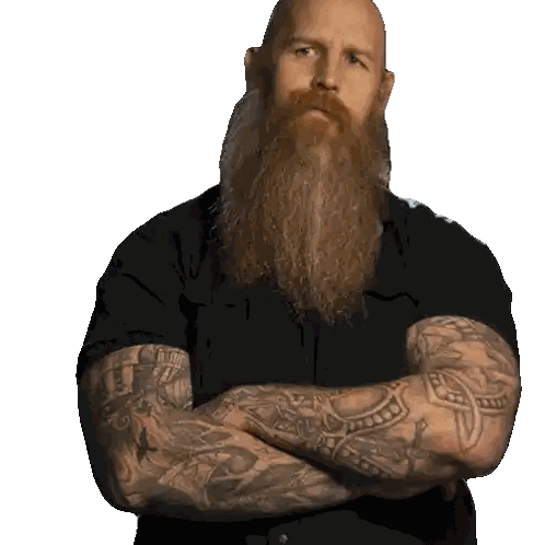 Bald Man With Long Beard and Tattoos Arms Crossed