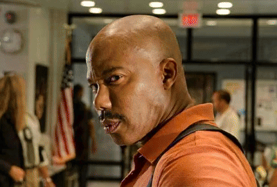 Bald Man with Mustache in Orange Shirt
