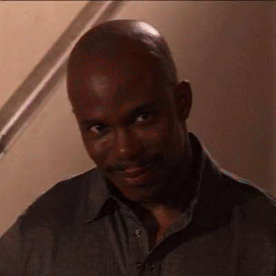 Bald Man With Mustache Looking at Camera