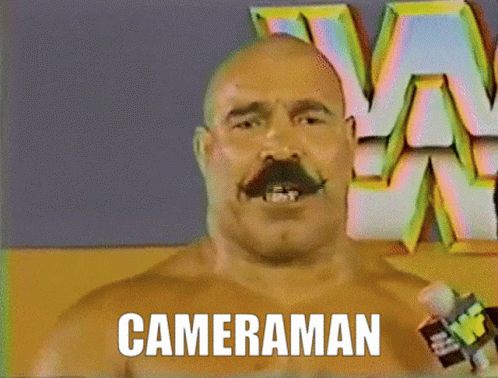 Bald Man with Mustache Saying Cameraman